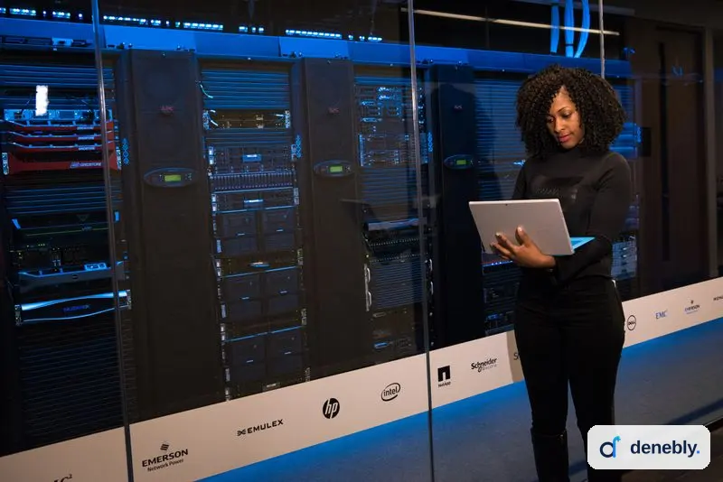 Engineer with a laptop inside a data center